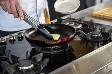 Put the butter in the pan.