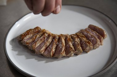 Season the veal entrecote to taste with herbs