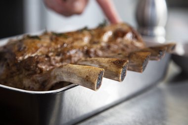 Remove the herbs and garlic from the veal.
