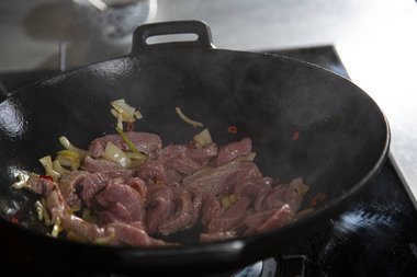 When the oil is hot add the veal.